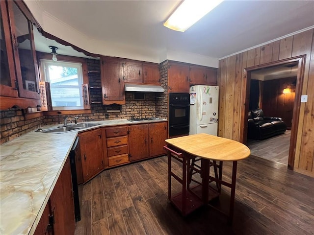 1638 Stafford St, Gretna, LA 70053 - kitchen with freestanding refrigerator, ornamental molding, dark wood finished floors, light countertops, and under cabinet range hood