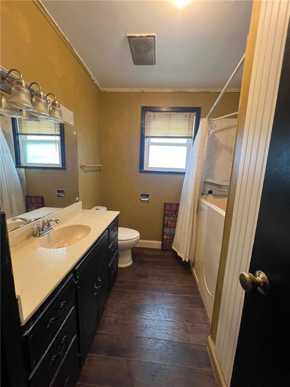 1638 Stafford St, Gretna, LA 70053 - bathroom with vanity, ornamental molding, wood-type flooring, plenty of natural light, and toilet
