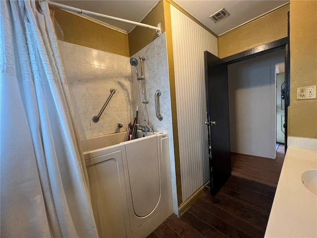 1638 Stafford St, Gretna, LA 70053 - full bathroom with hardwood / wood-style floors, crown molding, washer / clothes dryer, vanity, and shower / bath combo