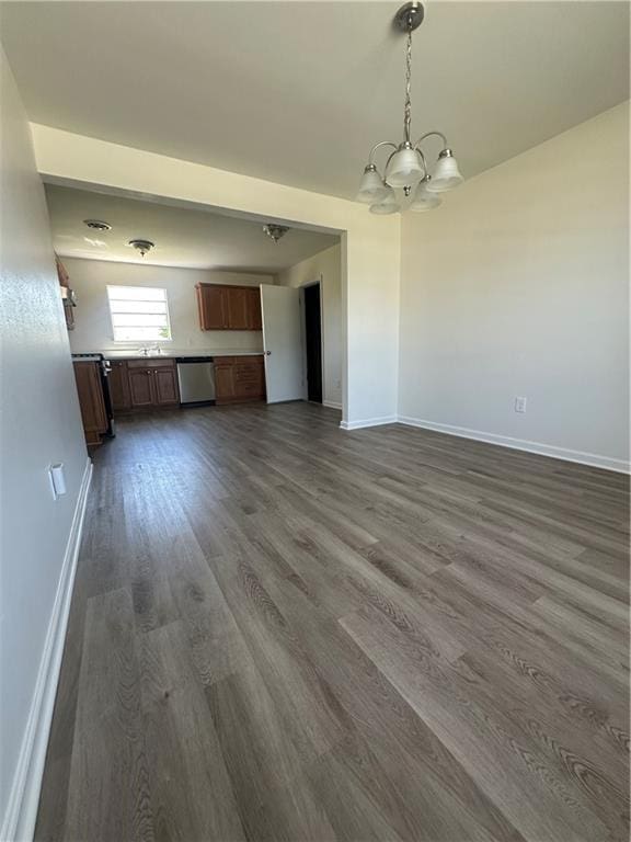 733 Morningside Dr, Gretna, LA 70056 - unfurnished living room featuring a chandelier, dark wood-style floors, and baseboards