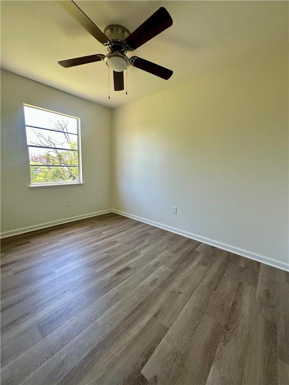 733 Morningside Dr, Gretna, LA 70056 - empty room featuring dark wood finished floors, baseboards, and ceiling fan