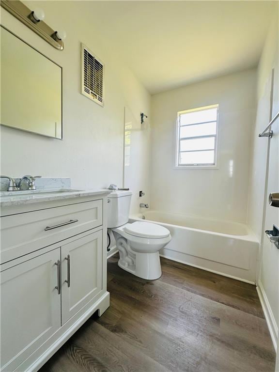 733 Morningside Dr, Gretna, LA 70056 - full bathroom featuring vanity, wood finished floors, toilet, and tub / shower combination