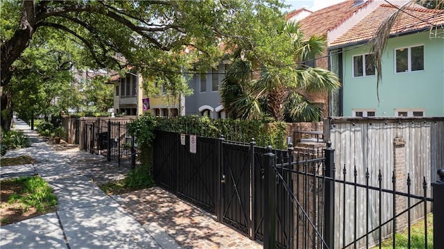 2627 S Carrollton Ave, New Orleans, LA 70118 - view of front of property featuring a gate, a tile roof, and stucco siding