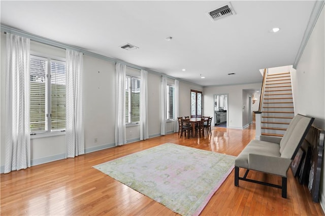 2627 S Carrollton Ave, New Orleans, LA 70118 - living room with ornamental molding, stairway, baseboards, light wood-style floors, and recessed lighting