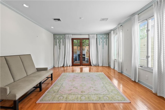 2627 S Carrollton Ave, New Orleans, LA 70118 - sitting room featuring french doors, plenty of natural light, baseboards, wood finished floors, and ornamental molding