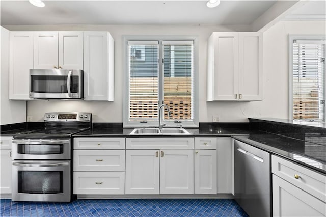 2627 S Carrollton Ave, New Orleans, LA 70118 - kitchen featuring appliances with stainless steel finishes, a sink, tile patterned flooring, and plenty of natural light