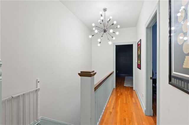 2627 S Carrollton Ave, New Orleans, LA 70118 - corridor with an upstairs landing, a chandelier, and light wood-type flooring
