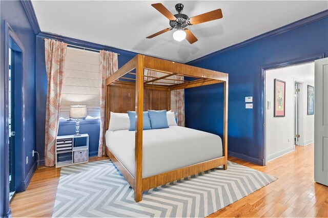 2627 S Carrollton Ave, New Orleans, LA 70118 - bedroom featuring wood finished floors, baseboards, ornamental molding, and a ceiling fan