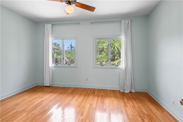 2627 S Carrollton Ave, New Orleans, LA 70118 - empty room featuring wood finished floors, a ceiling fan, and baseboards