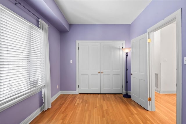 2627 S Carrollton Ave, New Orleans, LA 70118 - unfurnished bedroom featuring light wood-type flooring, a closet, and baseboards