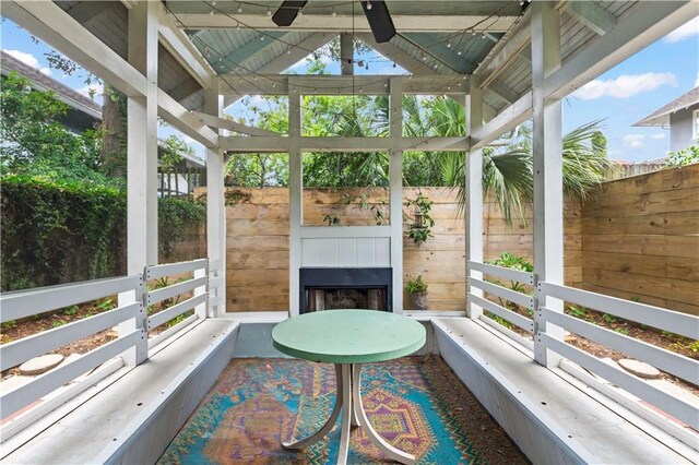 2627 S Carrollton Ave, New Orleans, LA 70118 - sunroom / solarium with a fireplace, a ceiling fan, plenty of natural light, and lofted ceiling