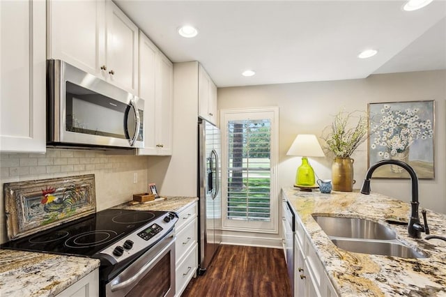 8 S Court Villa Unit 8, Mandeville, LA 70471 - kitchen with stainless steel appliances, a sink, dark wood finished floors, white cabinets, and recessed lighting