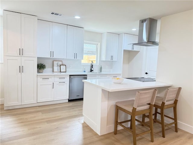 4413 Napoli Dr, Metairie, LA 70002 - kitchen featuring stainless steel dishwasher, island range hood, light wood-type flooring, white cabinetry, and light countertops