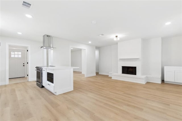 4413 Napoli Dr, Metairie, LA 70002 - unfurnished living room featuring light wood-type flooring, a fireplace, and recessed lighting