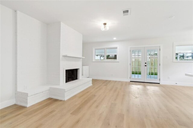 4413 Napoli Dr, Metairie, LA 70002 - unfurnished living room featuring light wood finished floors, a fireplace, french doors, and recessed lighting