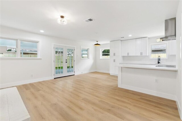 4413 Napoli Dr, Metairie, LA 70002 - unfurnished living room featuring light wood-style floors, recessed lighting, and french doors