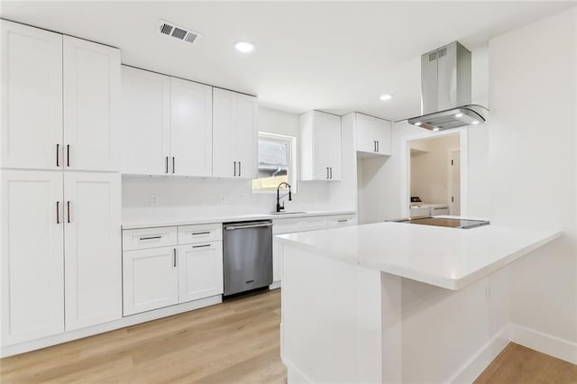 4413 Napoli Dr, Metairie, LA 70002 - kitchen with dishwasher, island exhaust hood, light wood-style flooring, a peninsula, and white cabinetry
