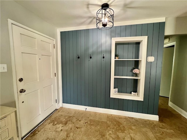 6021 Amhurst St, Metairie, LA 70003 - mudroom featuring baseboards and wooden walls