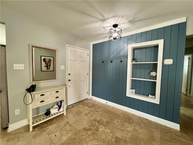 6021 Amhurst St, Metairie, LA 70003 - foyer featuring baseboards, wood walls, and stone finish floors