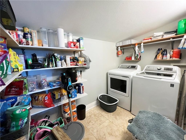 6021 Amhurst St, Metairie, LA 70003 - laundry area with washing machine and clothes dryer, baseboards, and a textured ceiling