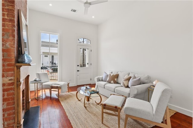 2417 Rousseau St, New Orleans, LA 70130 - living room featuring a ceiling fan, wood-type flooring, a brick fireplace, baseboards, and recessed lighting