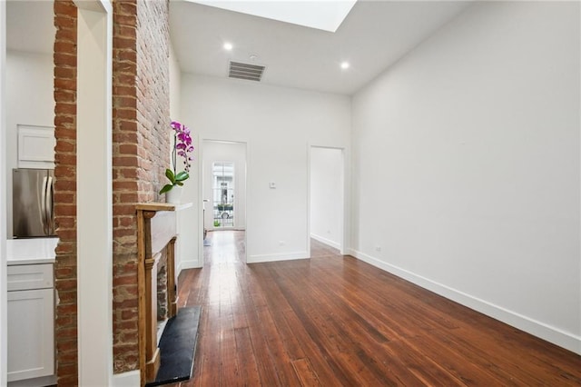 2417 Rousseau St, New Orleans, LA 70130 - corridor with dark wood-style floors, baseboards, recessed lighting, and a skylight