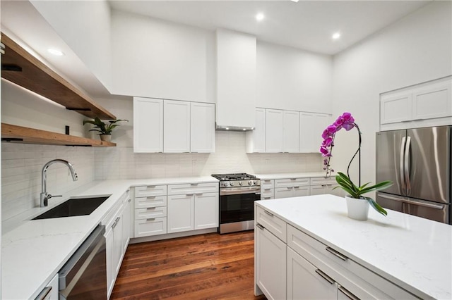 2417 Rousseau St, New Orleans, LA 70130 - kitchen featuring stainless steel appliances, a sink, open shelves, white cabinetry, and recessed lighting