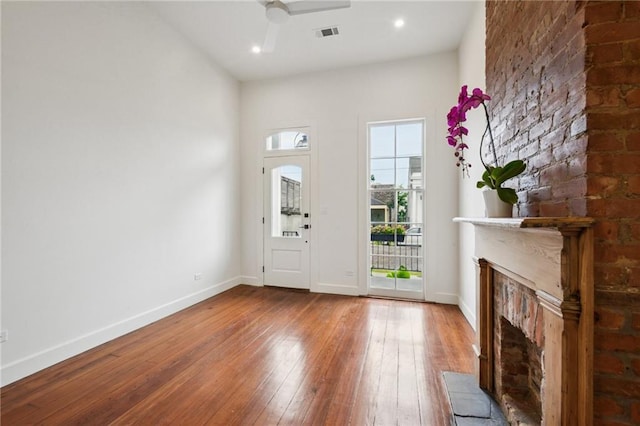 2417 Rousseau St, New Orleans, LA 70130 - entryway featuring hardwood / wood-style flooring, a fireplace with raised hearth, baseboards, a ceiling fan, and recessed lighting