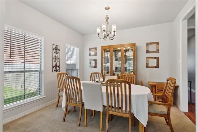 317 Haven Way, Lacombe, LA 70445 - dining area featuring a chandelier, healthy amount of natural light, baseboards, and light carpet