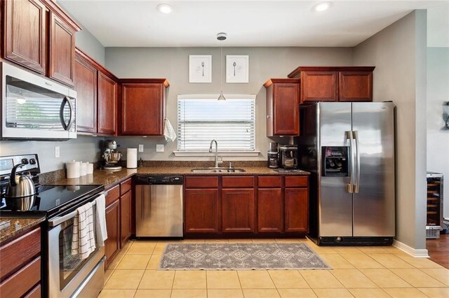 317 Haven Way, Lacombe, LA 70445 - kitchen with stainless steel appliances, a sink, recessed lighting, reddish brown cabinets, and dark stone counters
