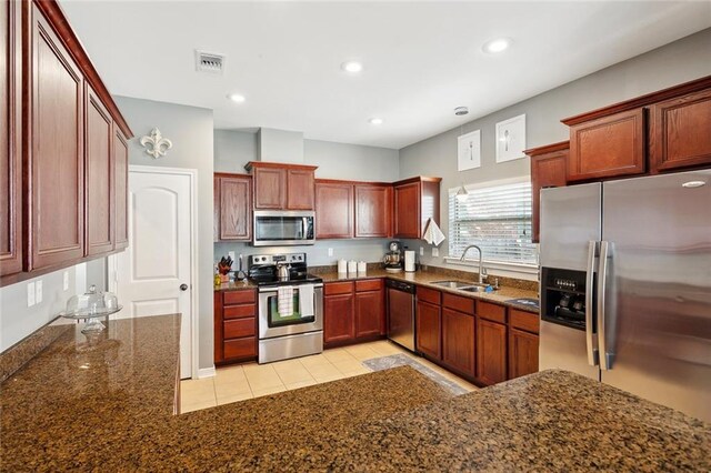 317 Haven Way, Lacombe, LA 70445 - kitchen with appliances with stainless steel finishes, a sink, dark stone counters, light tile patterned floors, and recessed lighting