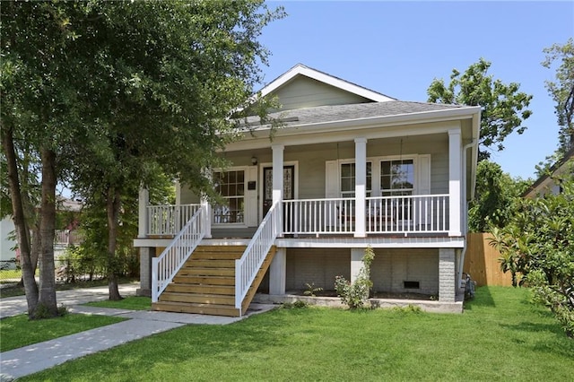 8521 Edinburgh St, New Orleans, LA 70118 - view of front of property featuring a front lawn, a porch, crawl space, stairway, and a shingled roof