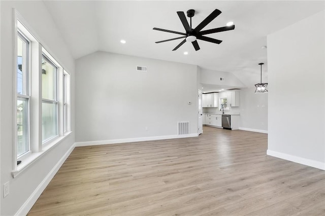 2925 Barataria Blvd, Marrero, LA 70072 - unfurnished living room featuring vaulted ceiling, light wood-style flooring, baseboards, a ceiling fan, and recessed lighting