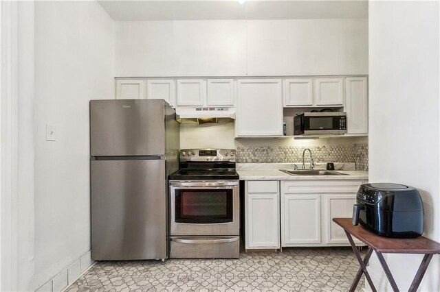 835 Saint Louis St Unit F, New Orleans, LA 70112 - kitchen with appliances with stainless steel finishes, a sink, under cabinet range hood, and white cabinets