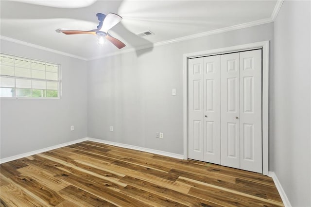 112 Oakwood Dr, Slidell, LA 70460 - unfurnished bedroom with crown molding, wood finished floors, baseboards, and a closet