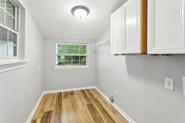 112 Oakwood Dr, Slidell, LA 70460 - washroom with cabinet space, wood finished floors, baseboards, and electric dryer hookup