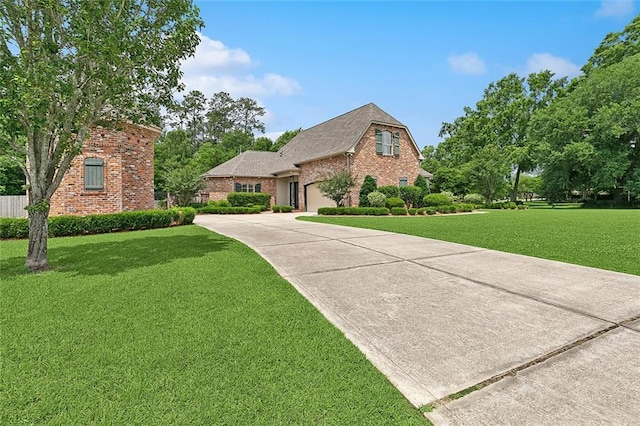 126 Tchefuncta Dr S, Covington, LA 70433 - view of front facade with brick siding, concrete driveway, and a front yard