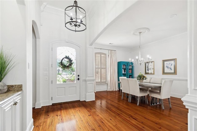 126 Tchefuncta Dr S, Covington, LA 70433 - entrance foyer with a chandelier, arched walkways, hardwood / wood-style flooring, and ornamental molding
