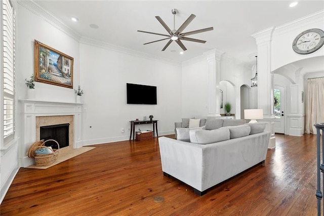126 Tchefuncta Dr S, Covington, LA 70433 - living room featuring ceiling fan, a fireplace with flush hearth, dark wood-type flooring, arched walkways, and recessed lighting