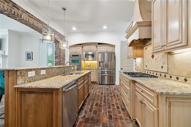 126 Tchefuncta Dr S, Covington, LA 70433 - kitchen featuring stainless steel appliances, a sink, custom range hood, brick flooring, and an island with sink
