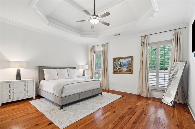 126 Tchefuncta Dr S, Covington, LA 70433 - bedroom with a tray ceiling, wood-type flooring, crown molding, ceiling fan, and baseboards