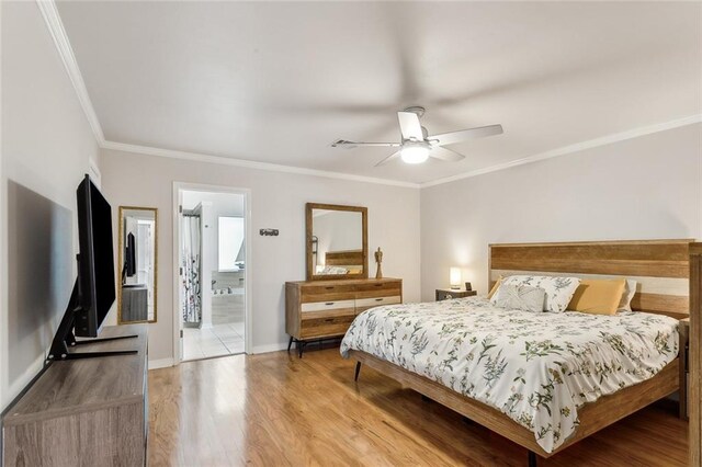 203 Willow Cir, Mandeville, LA 70471 - bedroom featuring crown molding, light wood-style floors, baseboards, ceiling fan, and connected bathroom