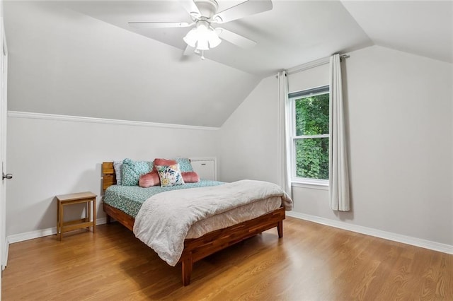 203 Willow Cir, Mandeville, LA 70471 - bedroom with vaulted ceiling, wood finished floors, ceiling fan, and baseboards