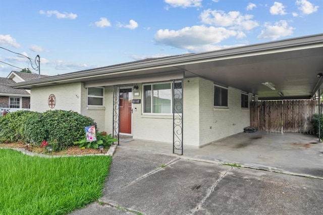 929 Carnation Ave, Metairie, LA 70001 - view of front of home featuring brick siding, a carport, and concrete driveway