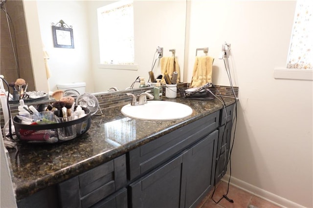 929 Carnation Ave, Metairie, LA 70001 - bathroom featuring vanity, toilet, tile patterned floors, and baseboards