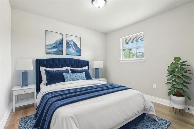 620 River Oaks Dr, New Orleans, LA 70131 - bedroom featuring baseboards and wood finished floors