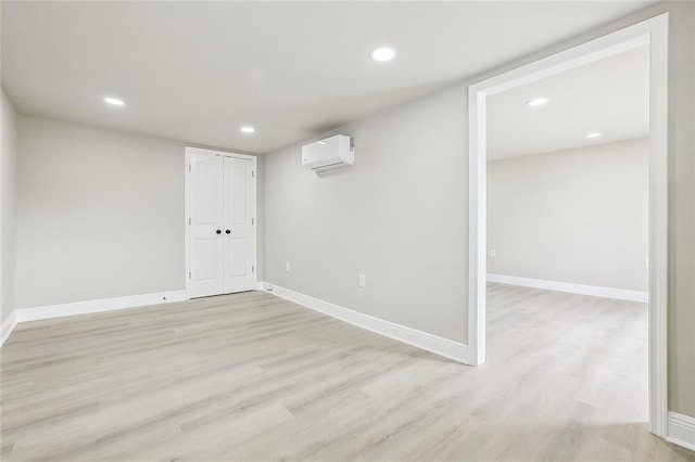 620 River Oaks Dr, New Orleans, LA 70131 - basement featuring a wall mounted AC, light wood-style floors, baseboards, and recessed lighting
