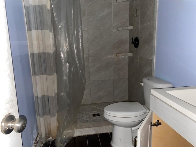 5425 Tulip Ct, Marrero, LA 70072 - bathroom featuring vanity, toilet, a tile shower, and tile patterned floors
