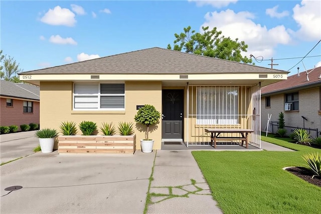 340709 Frenchmen St, New Orleans, LA 70122 - view of front facade with a front yard, cooling unit, and a shingled roof