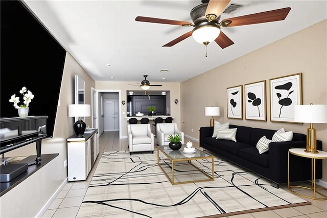 340709 Frenchmen St, New Orleans, LA 70122 - living room with ceiling fan, baseboards, and light tile patterned floors